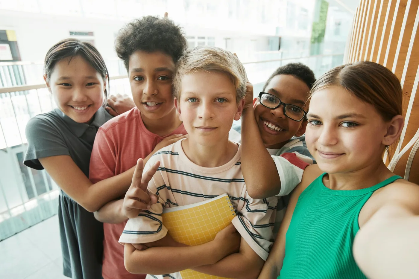 Diverse secondary school students smiling together