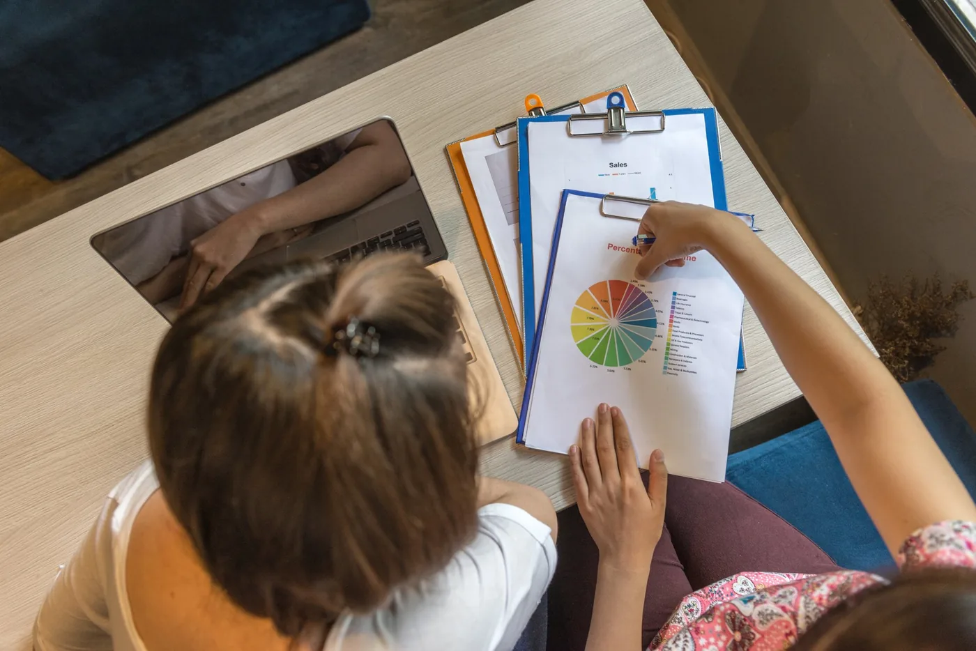 Two teachers reviewing pupil progress reports together